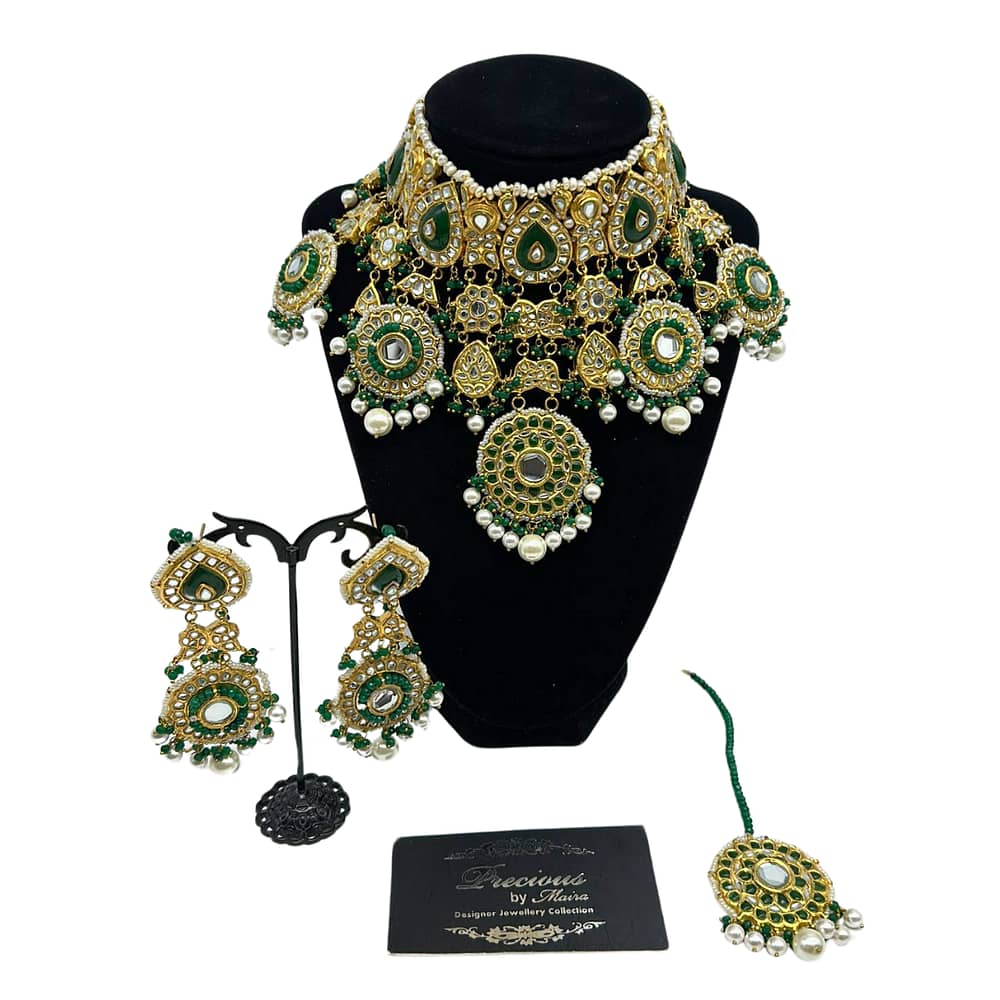 Statement kundan hanging style necklace in emeralds and real peaels with matching earrings and tikka