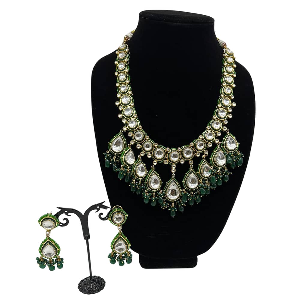 Uncut kundan Mala set with meena border and emerald droplets.