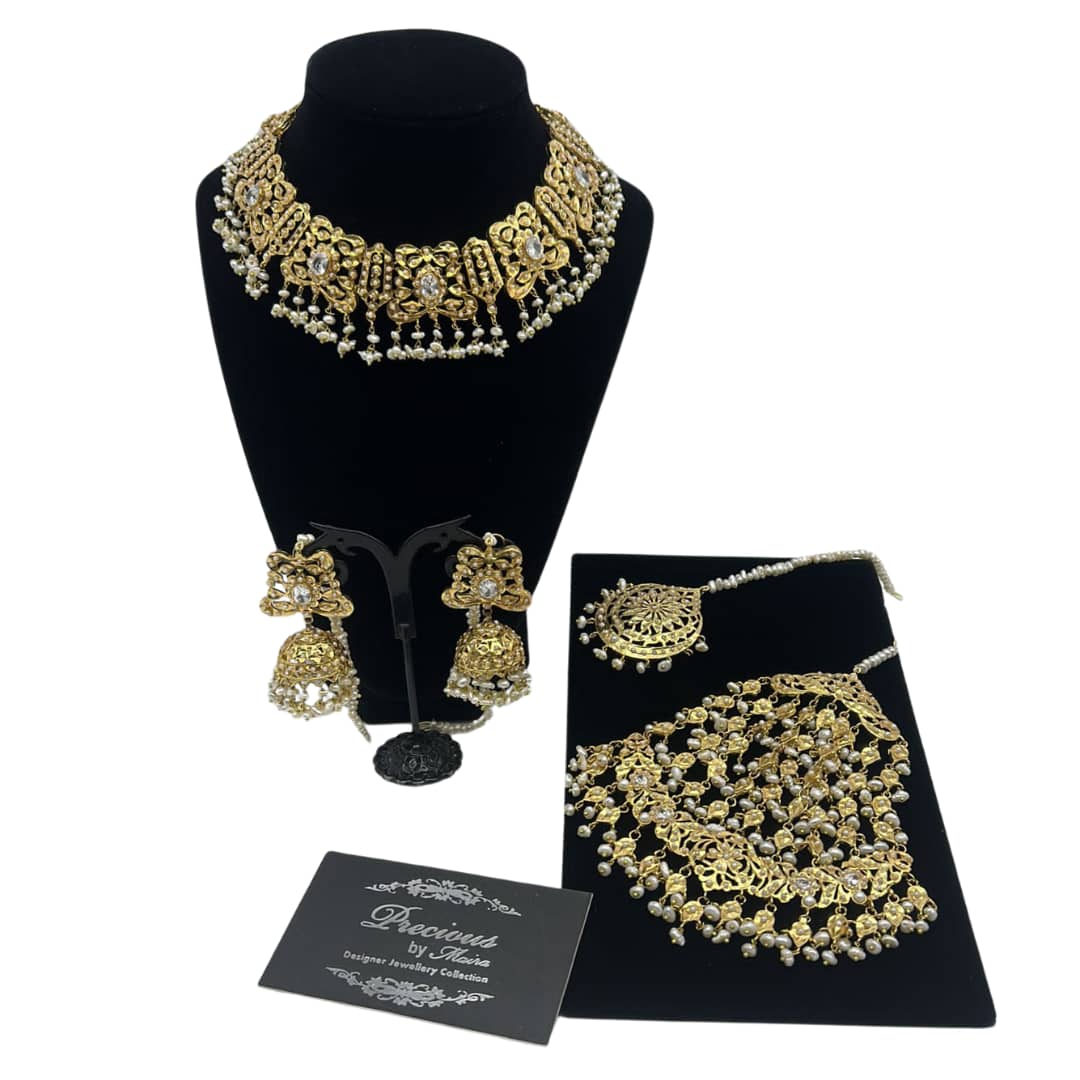 Delicately designed necklace set with statement jhoomer in real pearls finish