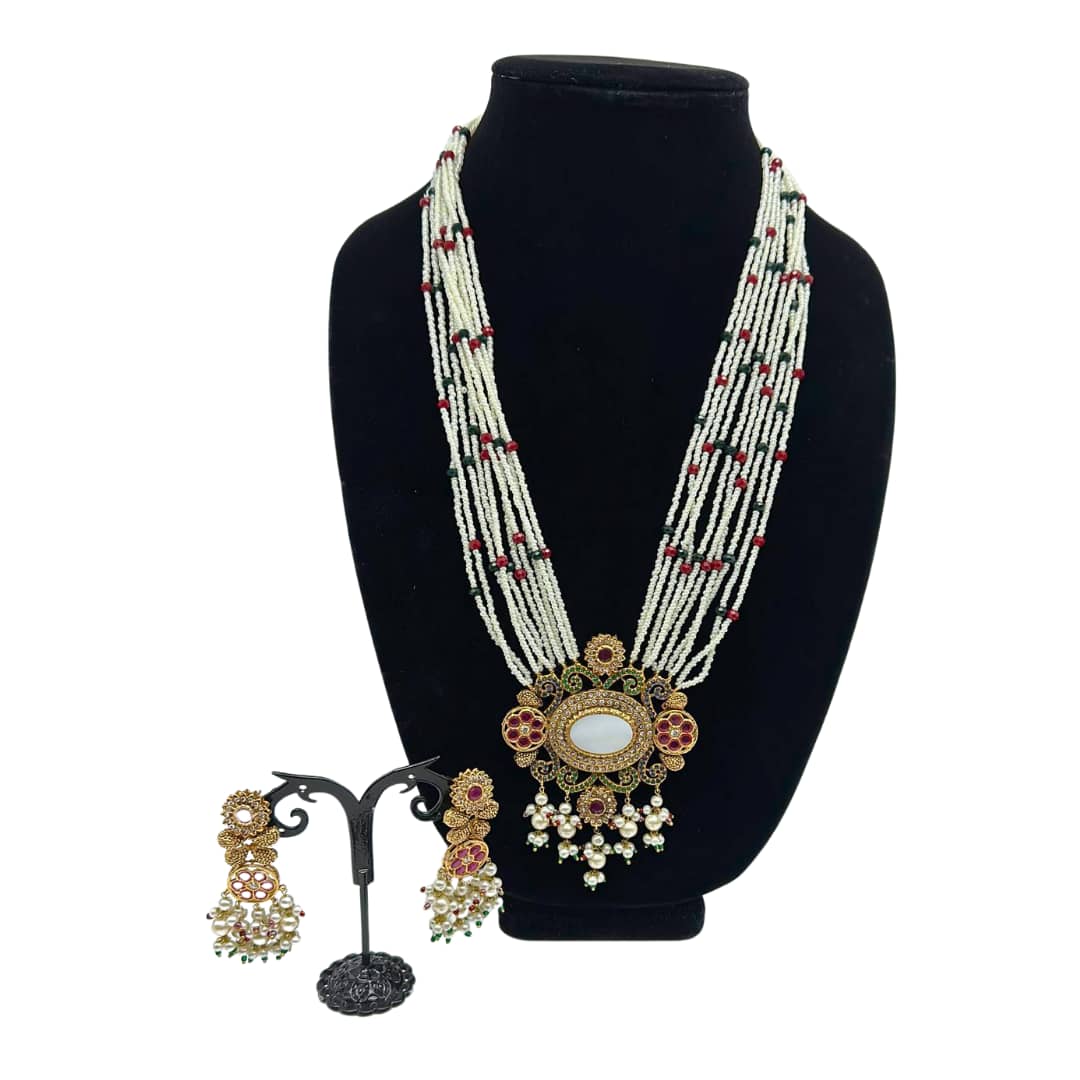 Handcrafted pendant style necklace set in ruby and emeralds and pearl strands