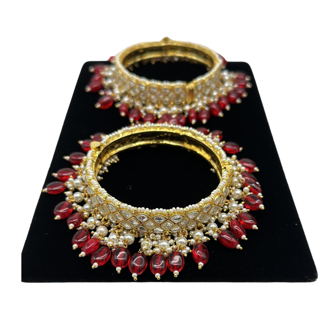 Pair of kundan bangles with lock and pearls and ruby hanging