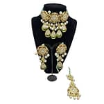 Beautifully crafted kundan set with mint green crystal strands in ruby, emeralds and pearls