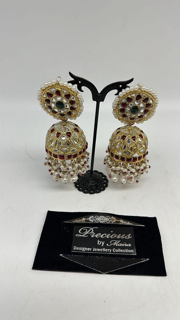 aKundan jhumkey with two tone colored kundan and real pearls finish