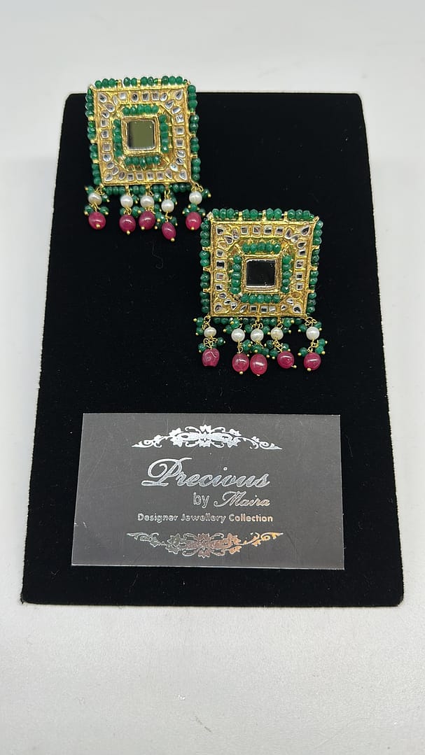 Kundan stud style earrings with semi precious emeralds border and ruby droplets